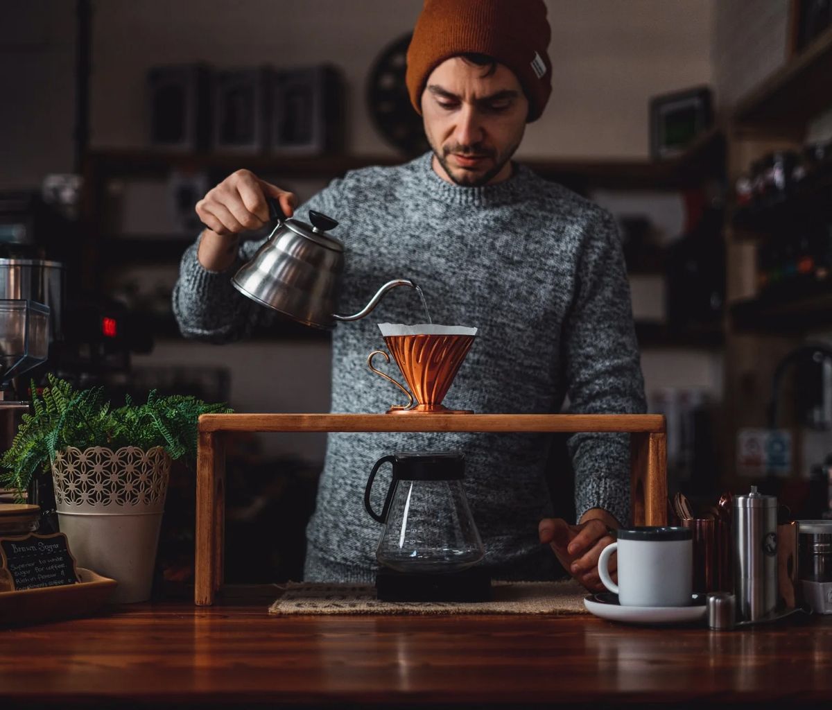 Matt from Copper Coffee Roasters in a beanie doing his pour over